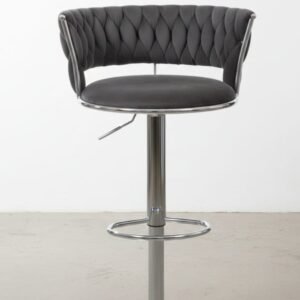 Taburete de bar tapizado en terciopelo con altura ajustable y base metálica.