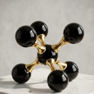 Decoración en forma de modelo molecular abstracto en negro y dorado.