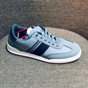 Zapatillas urbanas de color gris con franjas oscuras laterales, adecuadas para el uso diario.