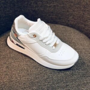 Zapatillas casuales de mujer de color blanco con detalles plateados.
